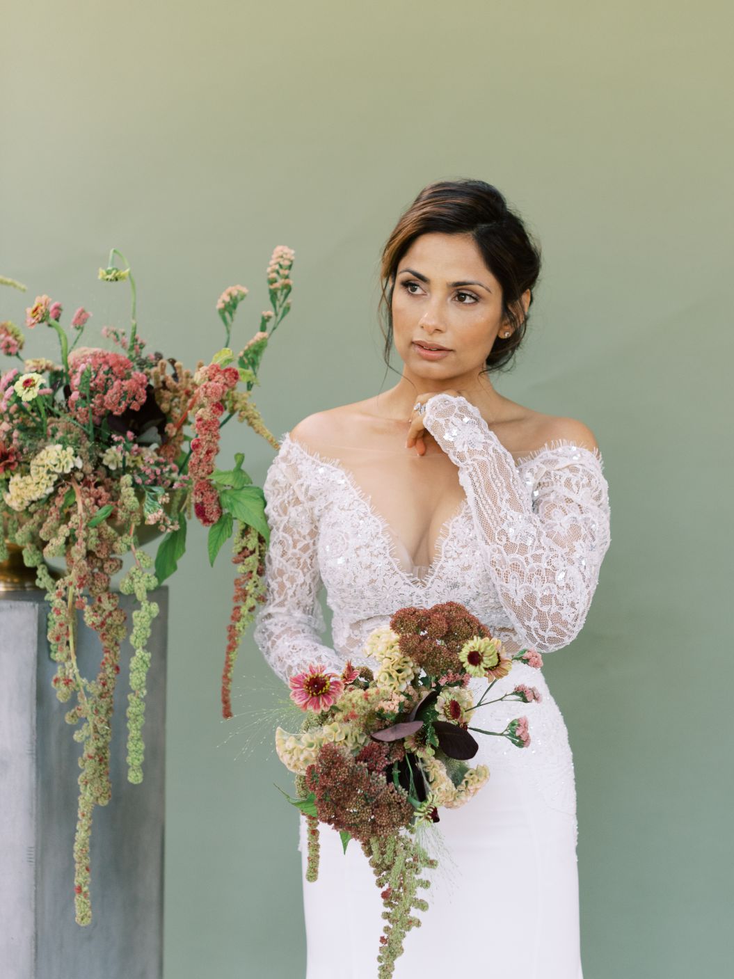 bride holding bouquet standing near flowers