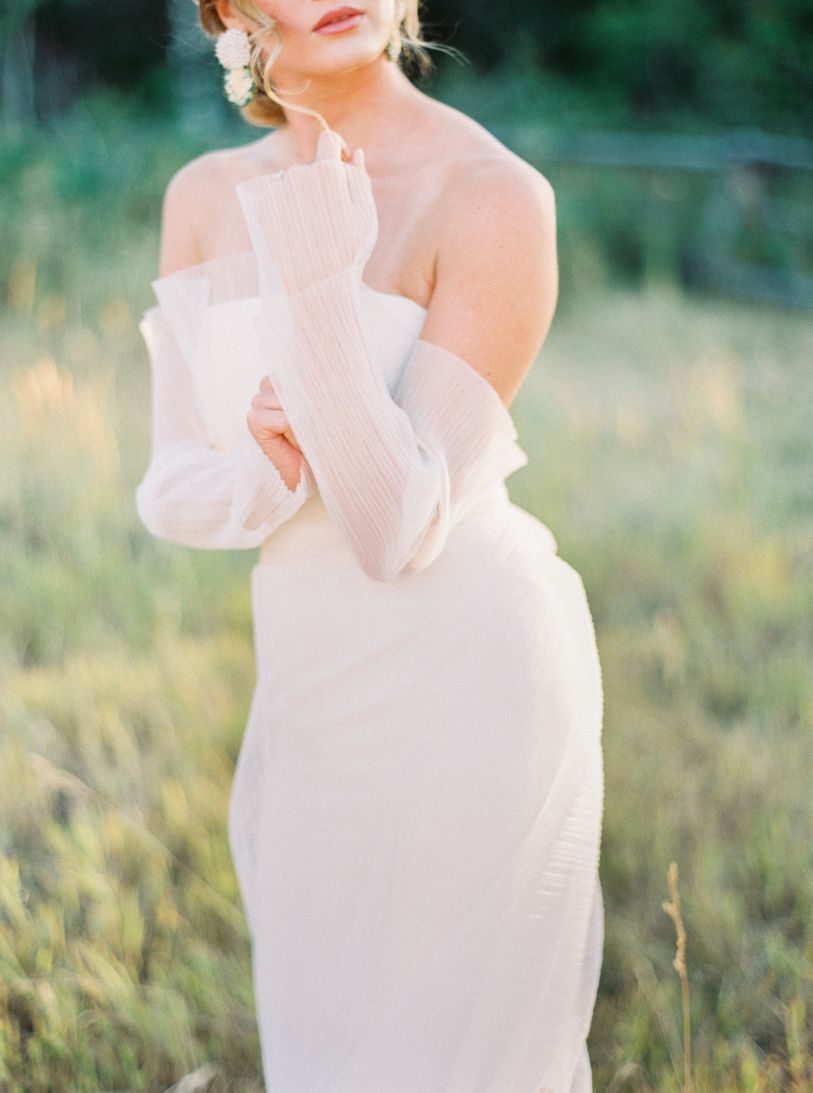 bride in grass field with pink red lipstick