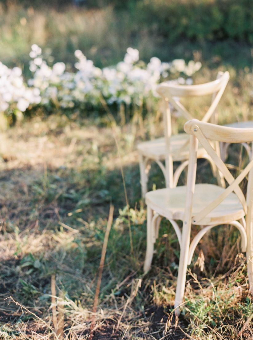 wedding chairs among woods and grass