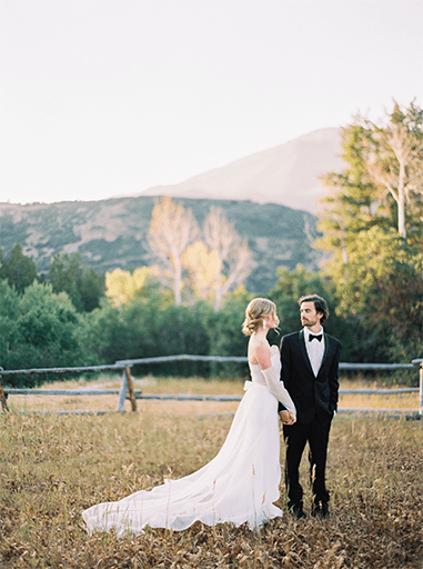 bride and groom standing in beautiful mountain scene