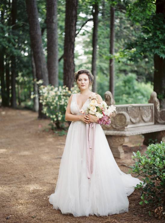 bride holding her bouquet in the woods