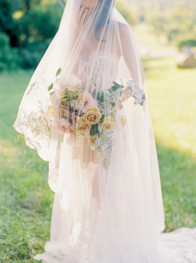 wedding portrait bride with veil draping over face and flowers