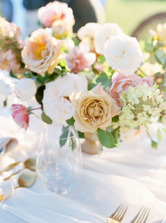 wedding table with colorful flowers and white tablecloth