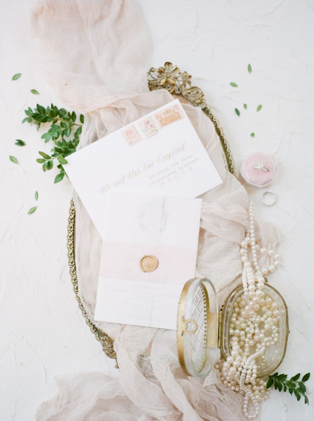 detailed shot of wedding invitation rings and jewelry