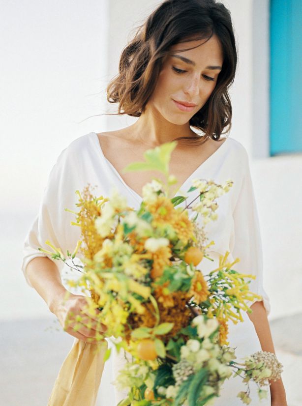 bride with bouquet displaying hair and soft makeup