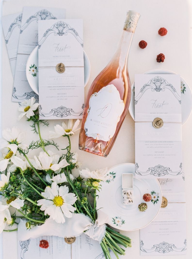 wedding menus, wine, and flowers on wedding table