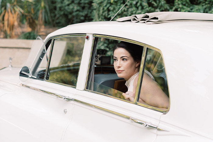bride sitting in car looking out the window