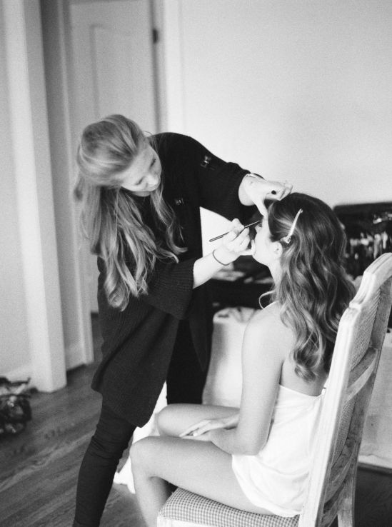 wedding hair and makeup artist preparing a bride